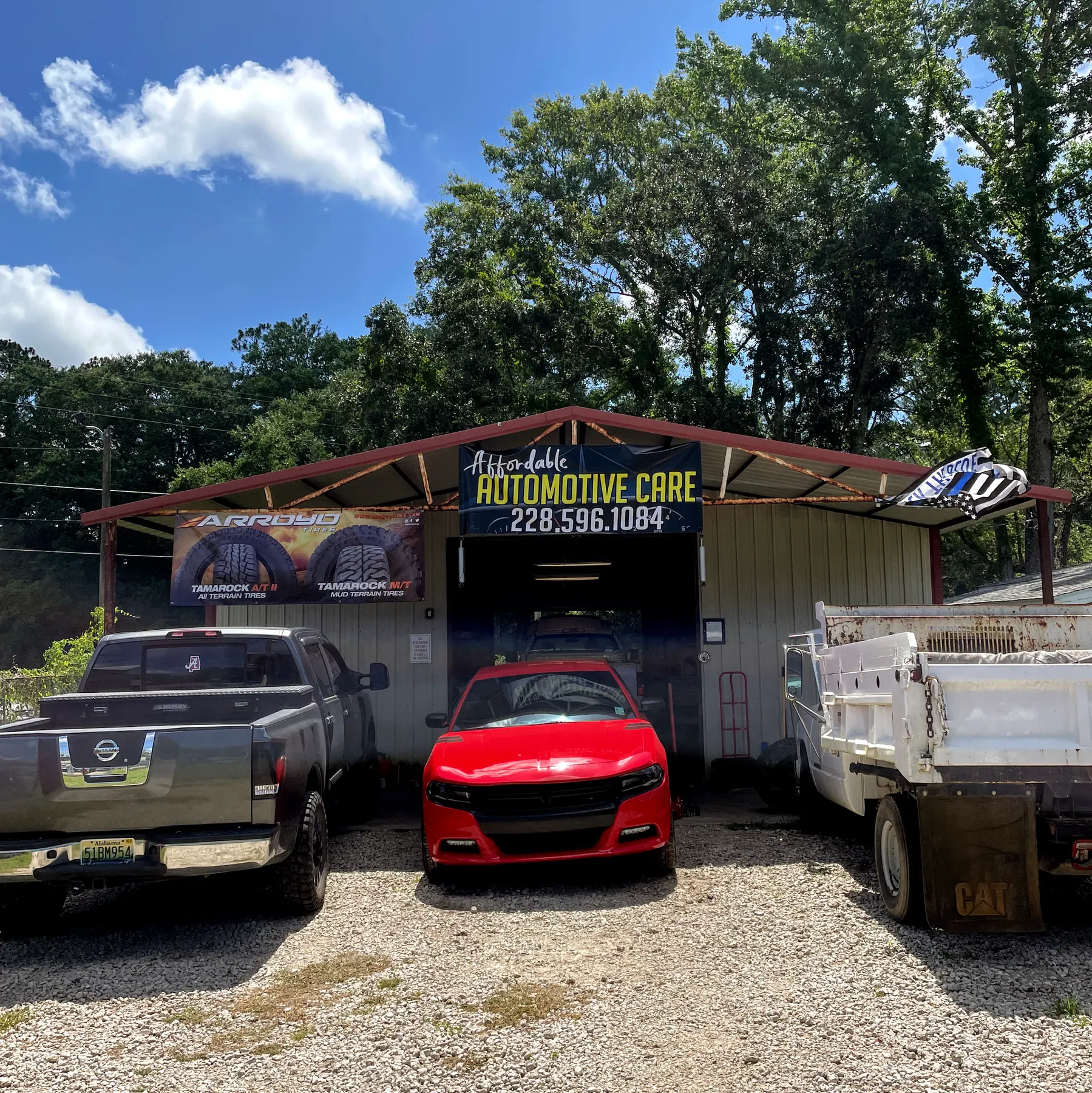 Our open bays from the front, a red car parked under the Affordable Automotive Care sign