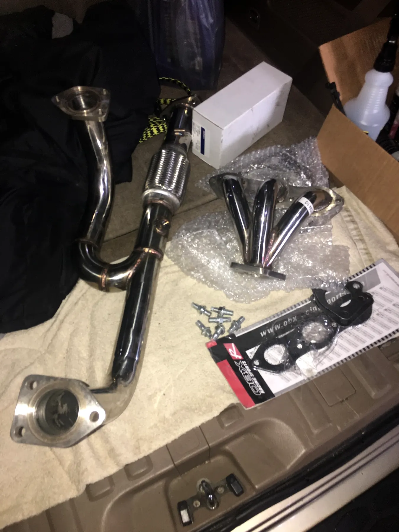 New exhaust pipes and gaskets laid out in our shop