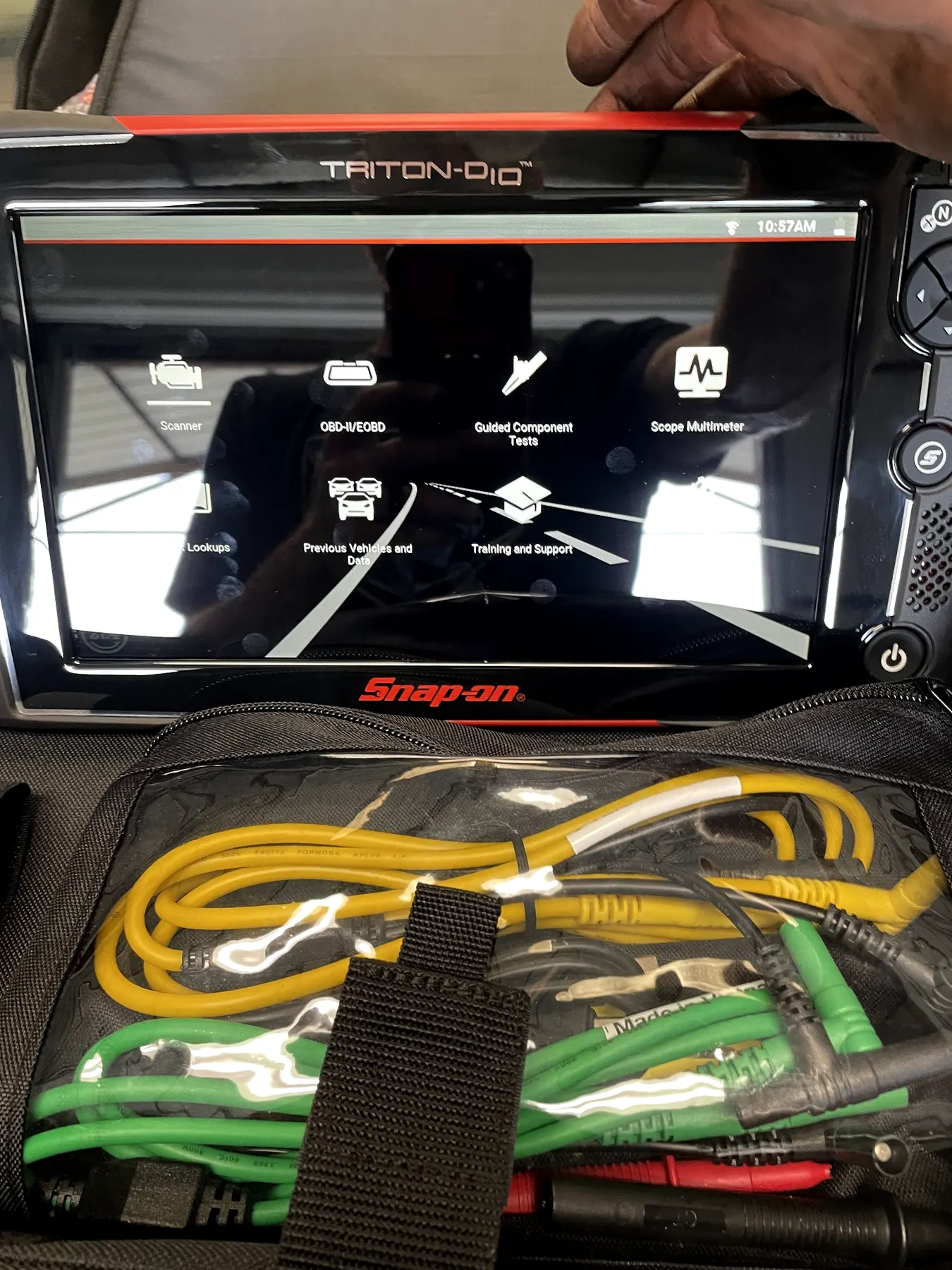 A Snap-on scan tool in its open case on a vehicle in our shop